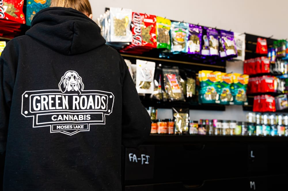 close up of green roads cannabis logo on employee sweatshirt