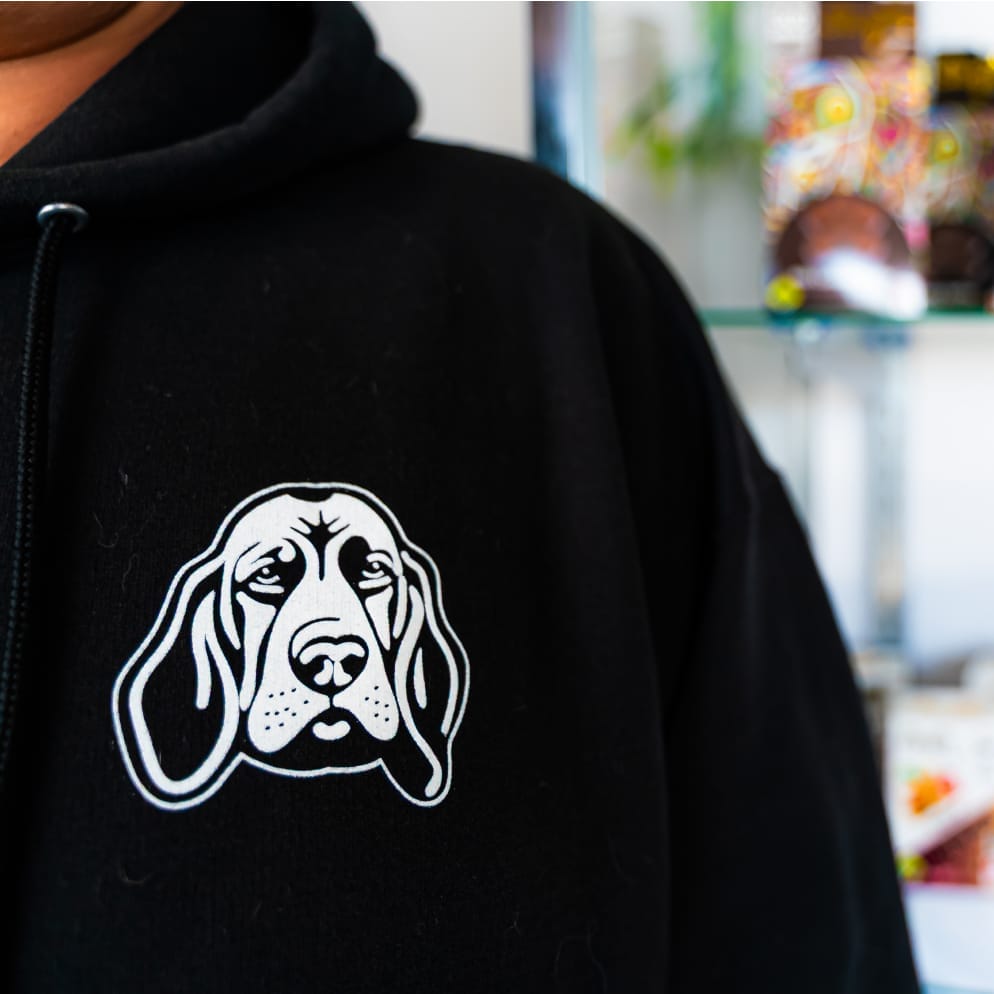 community-1 close up of green roads cannabis logo on employee sweatshirt